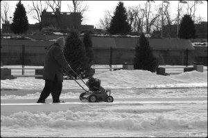 winter, montreal, hiver, man with lawnmover, homme avec tondeuse a gazon, montreal, olympic stadium, stade olympique