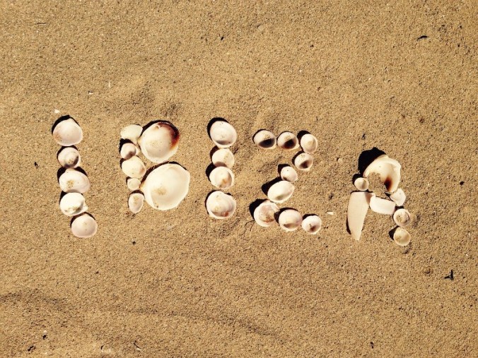 Ibiza spelled with sea shells on the sand.